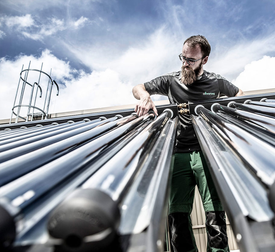 Ein Techniker überprüft eine Photovoltaikanlage in München, um die Effizienz der erneuerbaren Energien durch Klimatechnik zu optimieren.